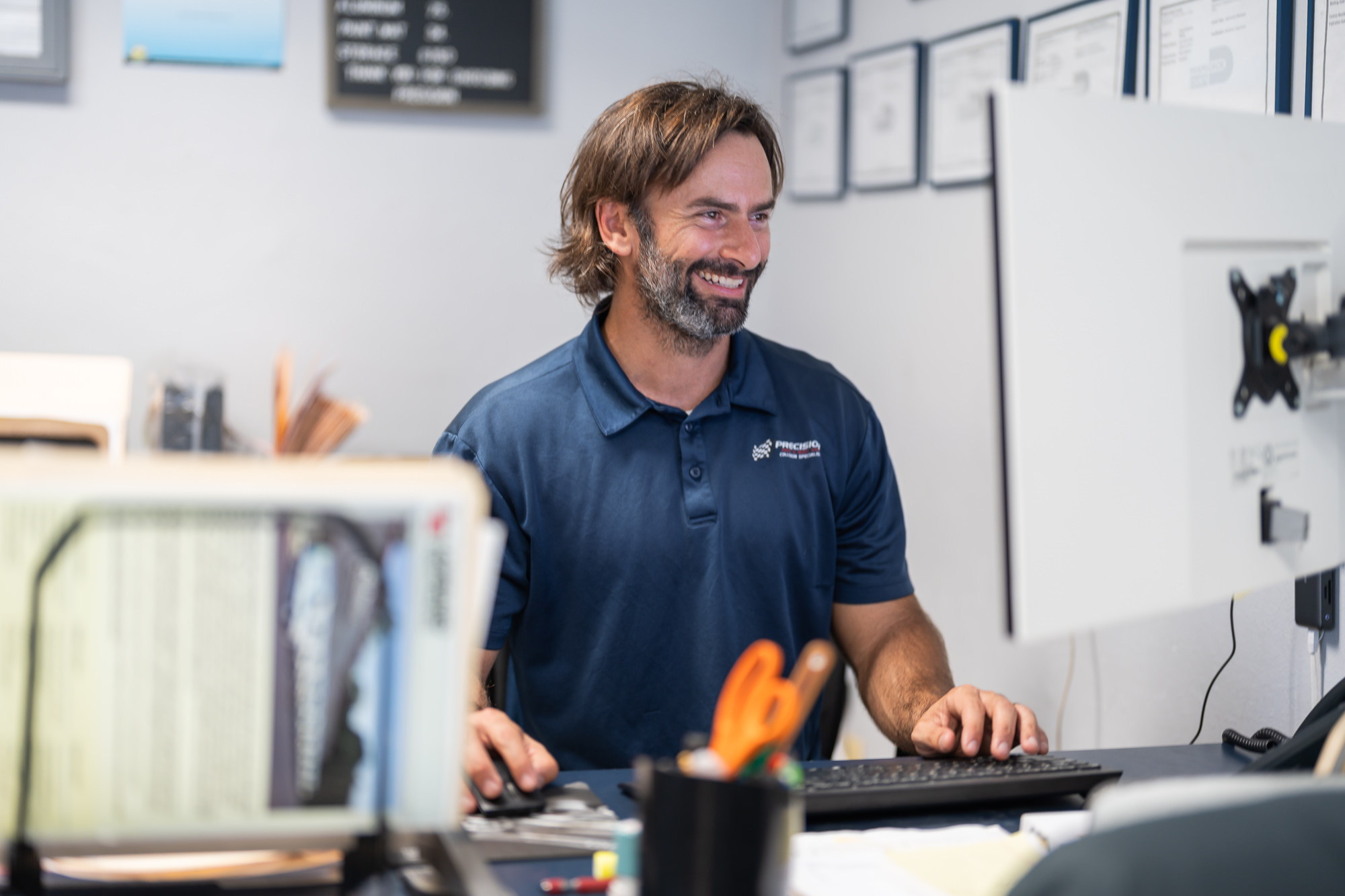 Precision Paint & Body Shop service manager at the front desk in Miami