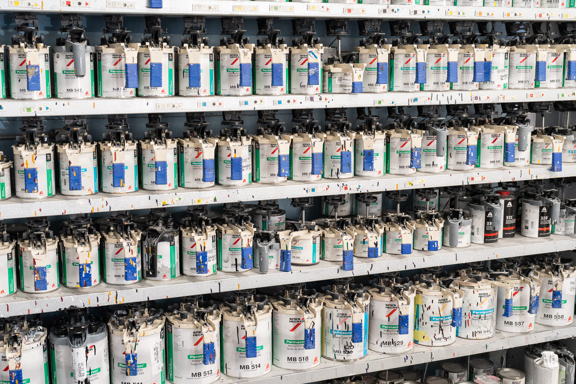 Rows of Spies Hecker Permacron paint canisters used for precision color-matching at Precision PBS Miami