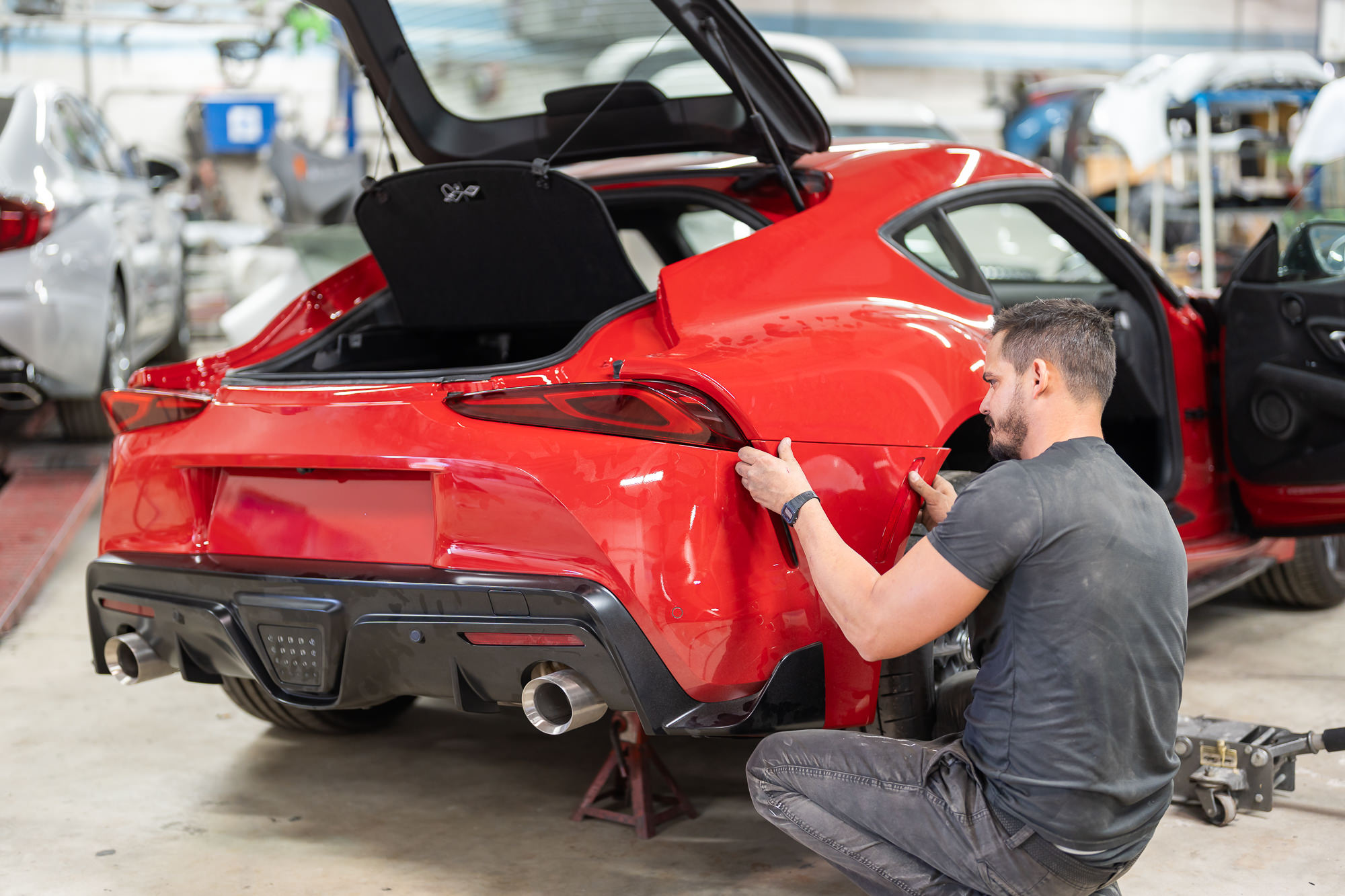 Vehicle with front end disassembled undergoing major collision repair at Precision PBS Miami